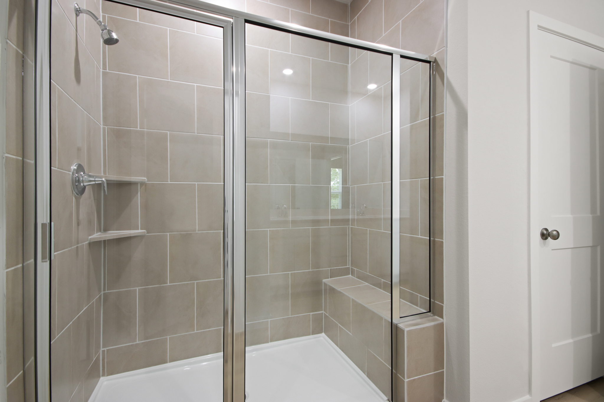 A shower with a glass door.
