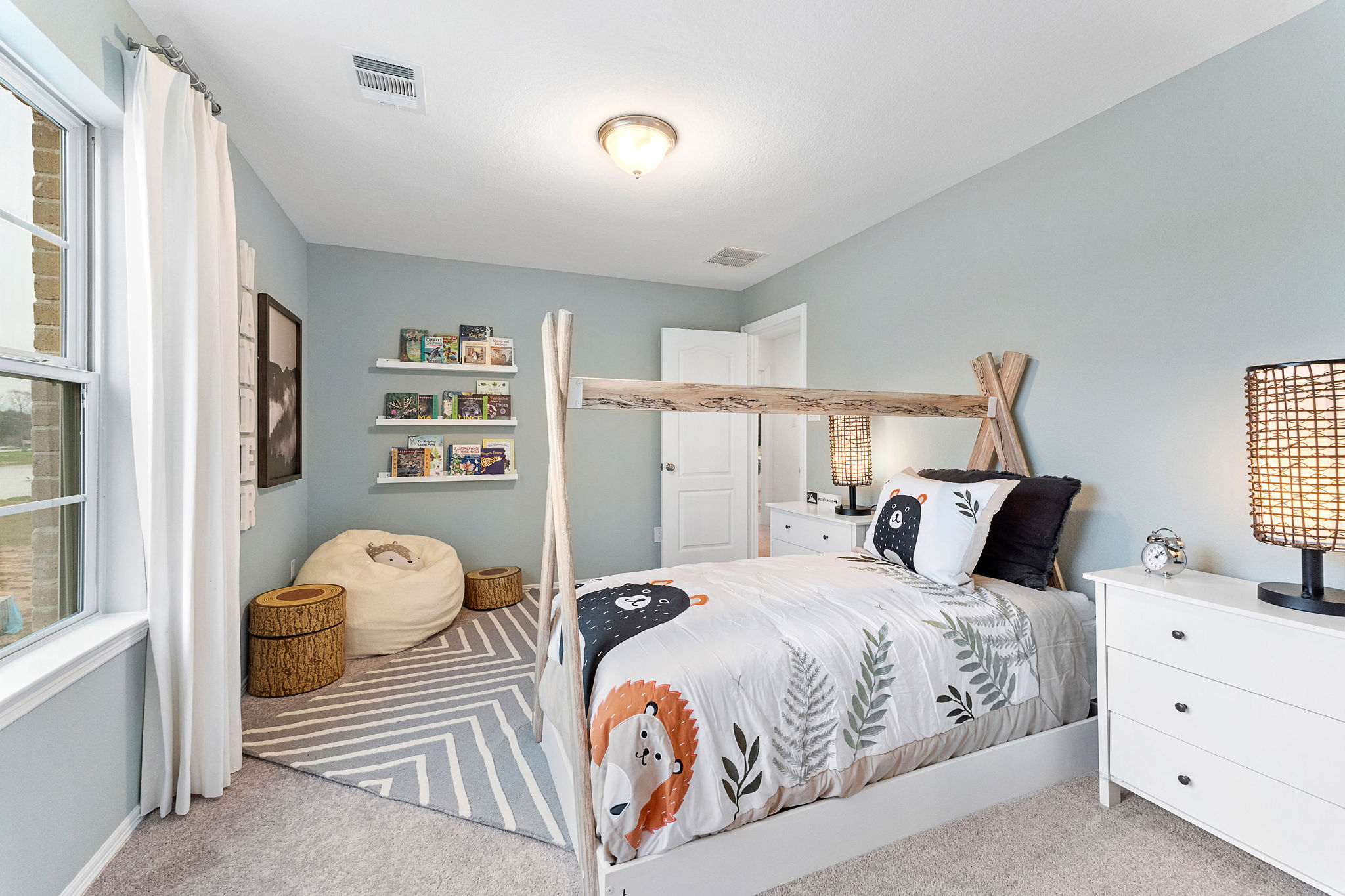 A bedroom with a bed and a shelf with books.
