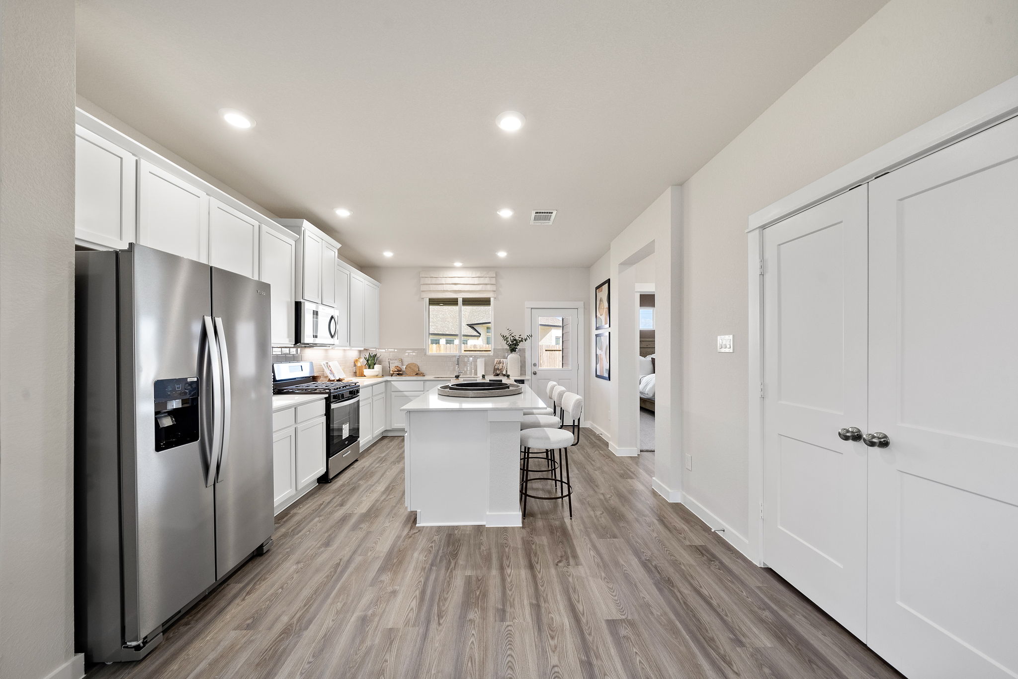 A kitchen with white cabinets.