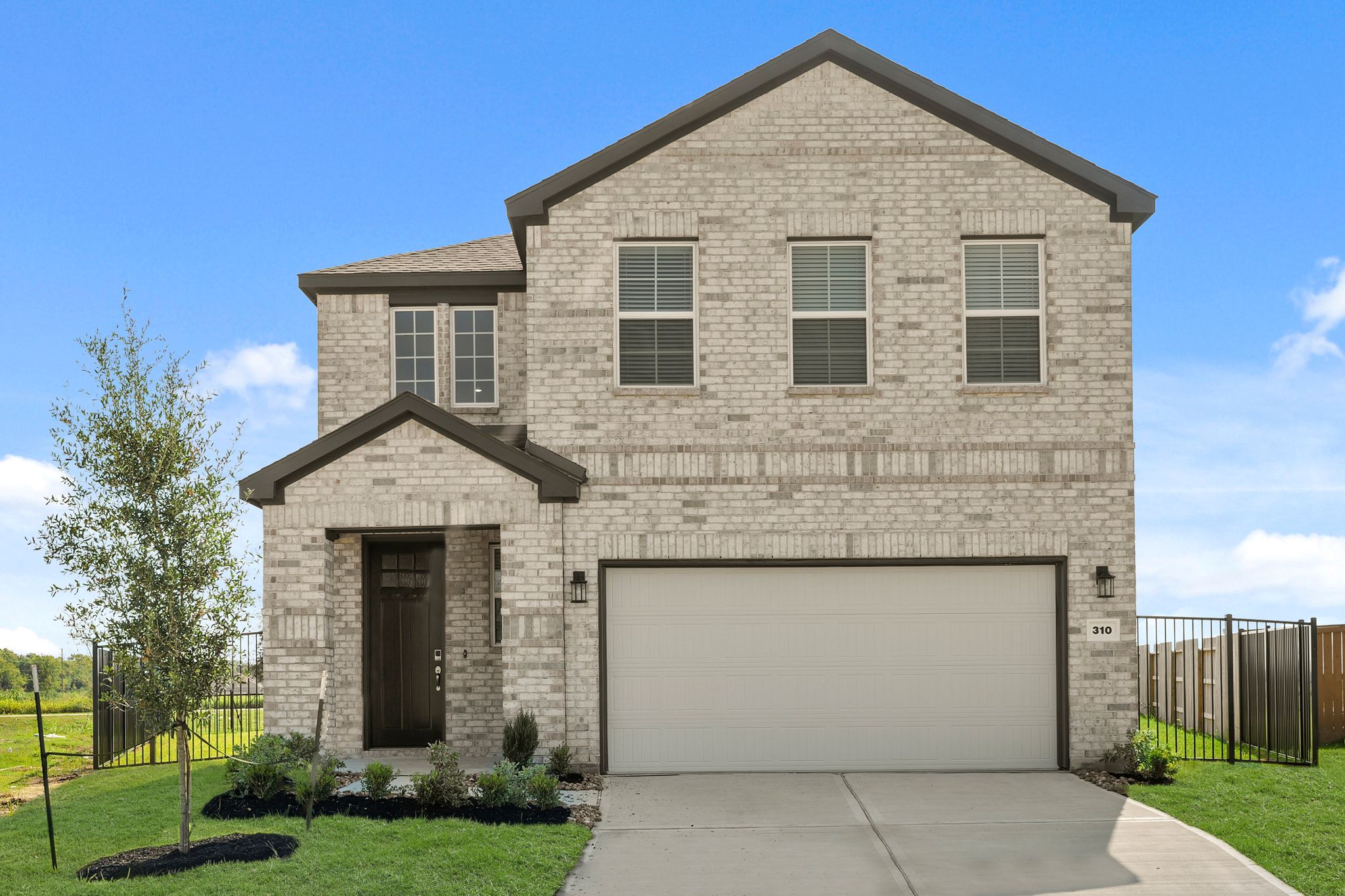 A grey house with a garage.