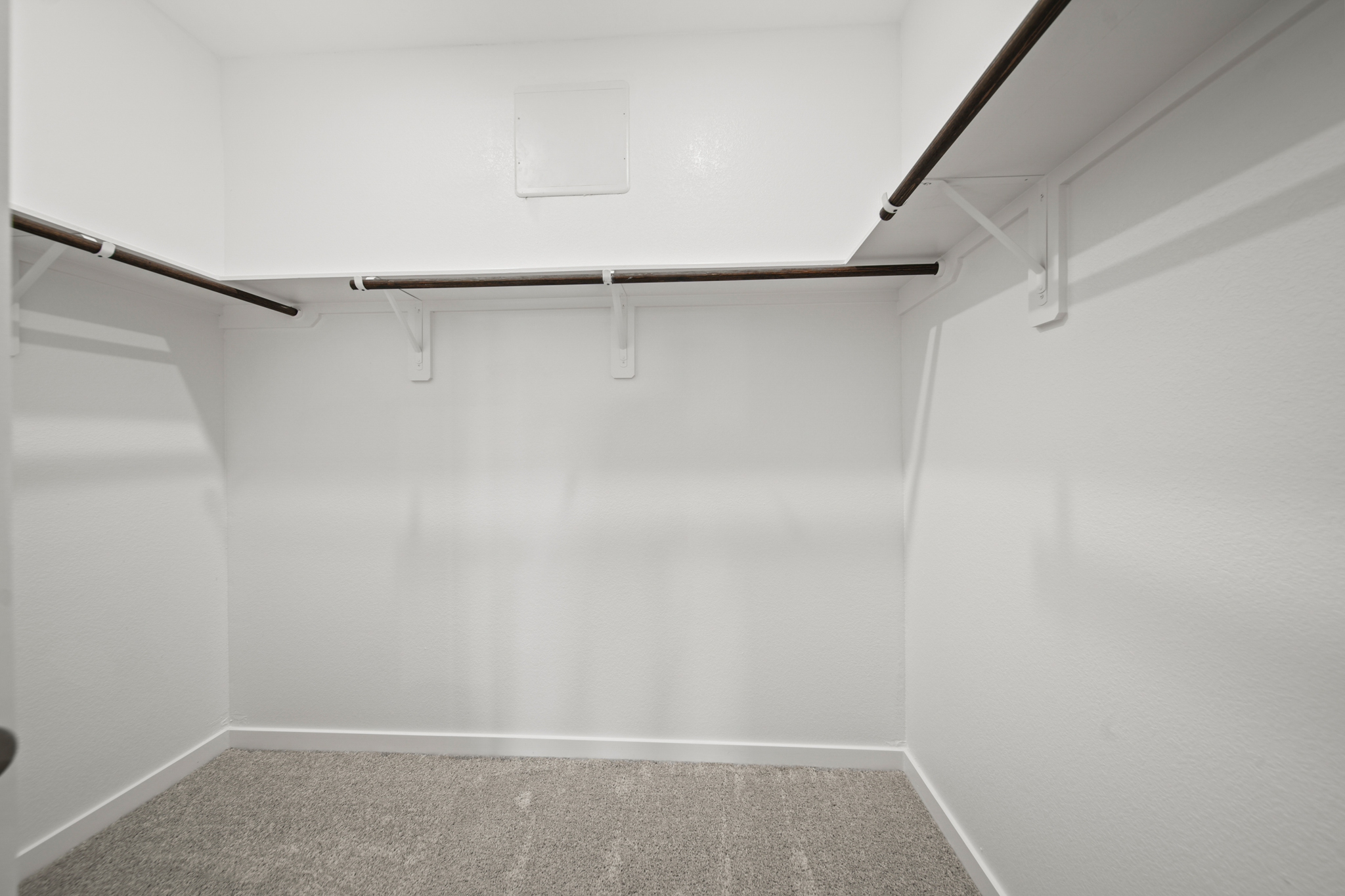 A white room with a metal railing.