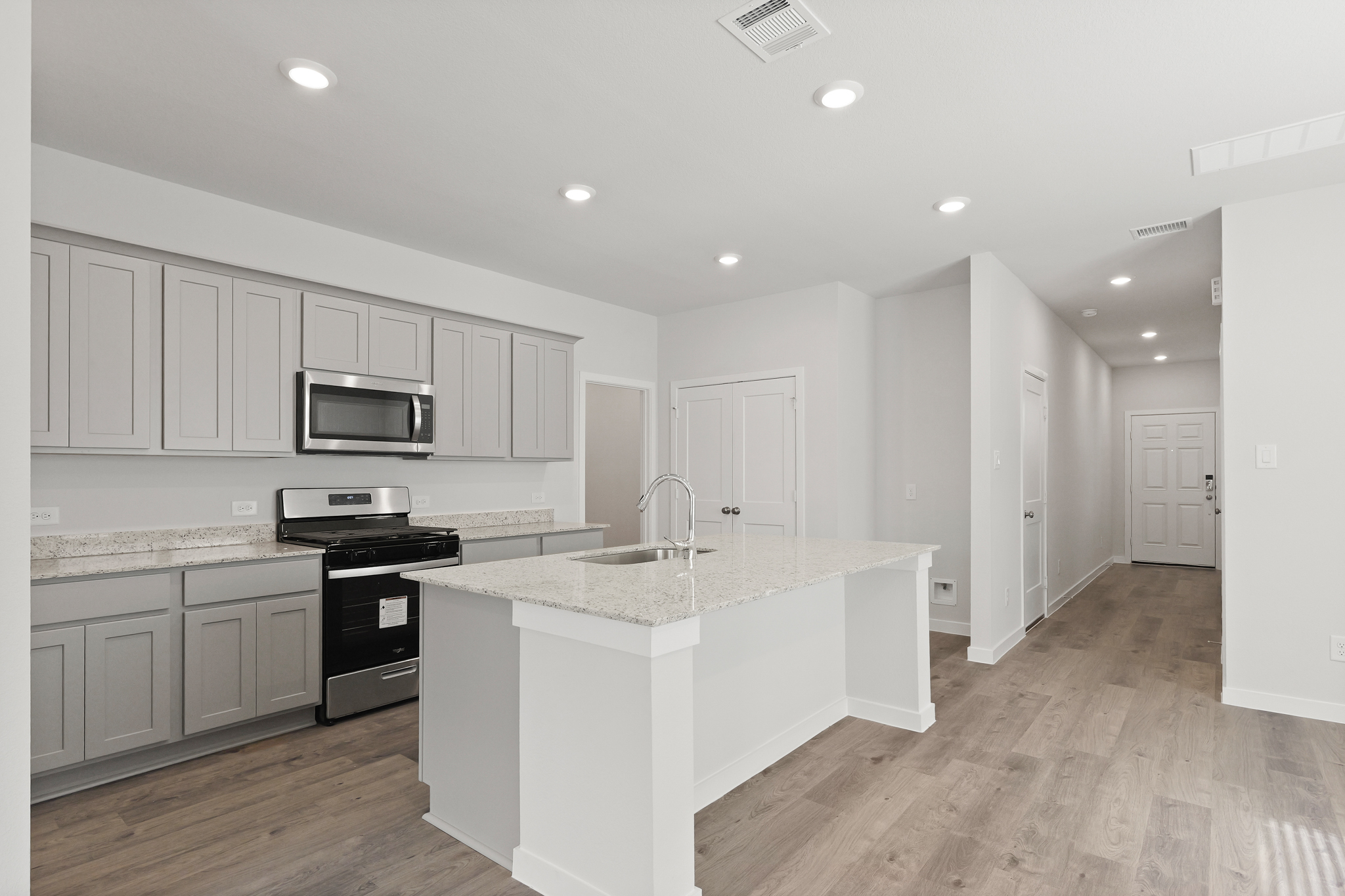 A kitchen with white cabinets.