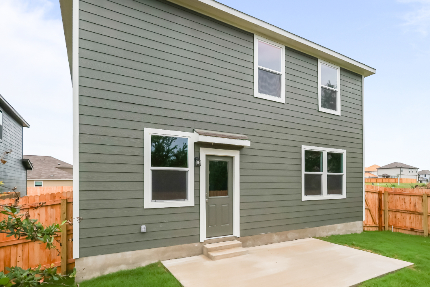 A grey house with a white door.
