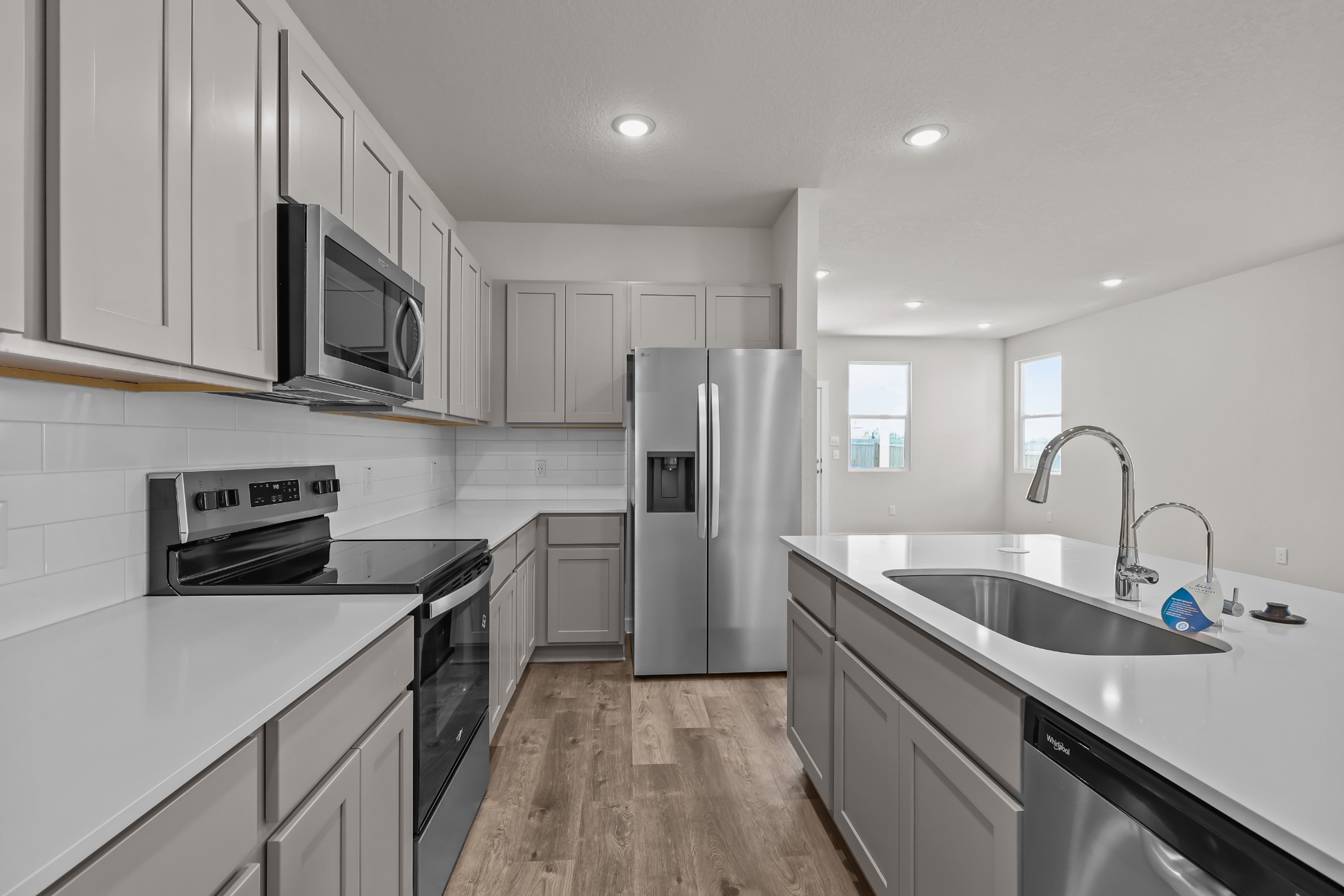 A kitchen with white cabinets.