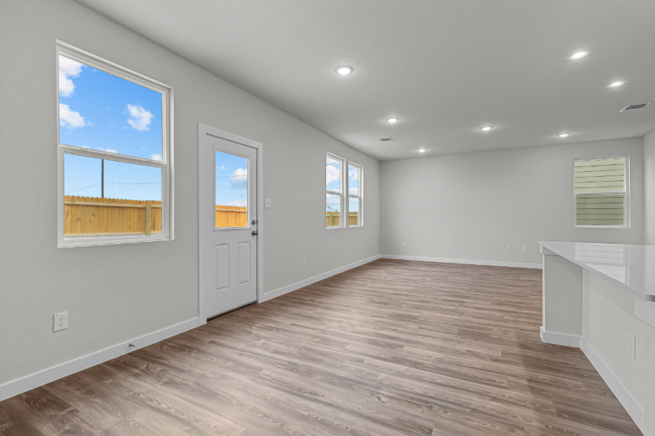 A room with a wood floor and white walls with a wood floor.