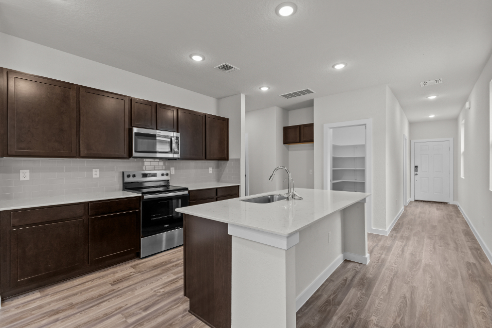 A kitchen with wooden cabinets.
