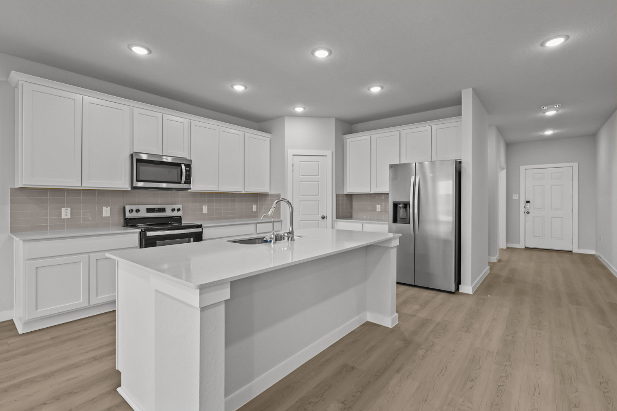 A kitchen with white cabinets.