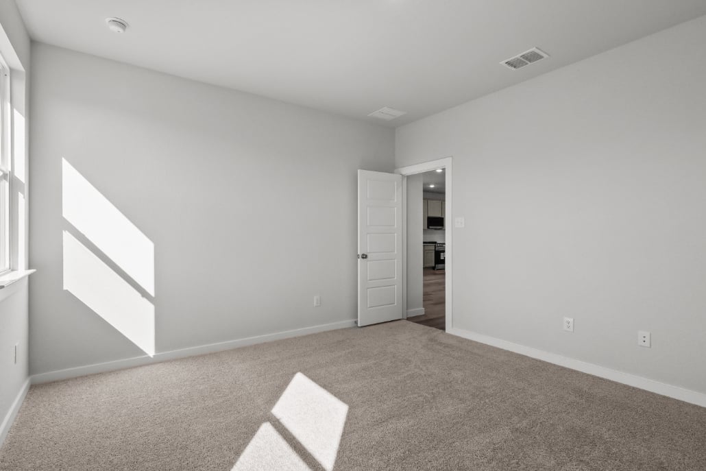 A room with a carpet and a rug.