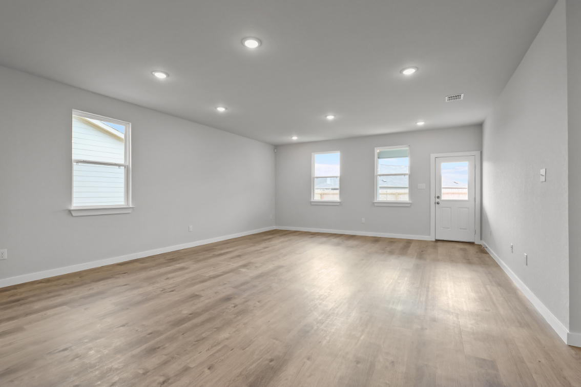 A room with a wood floor and white walls.