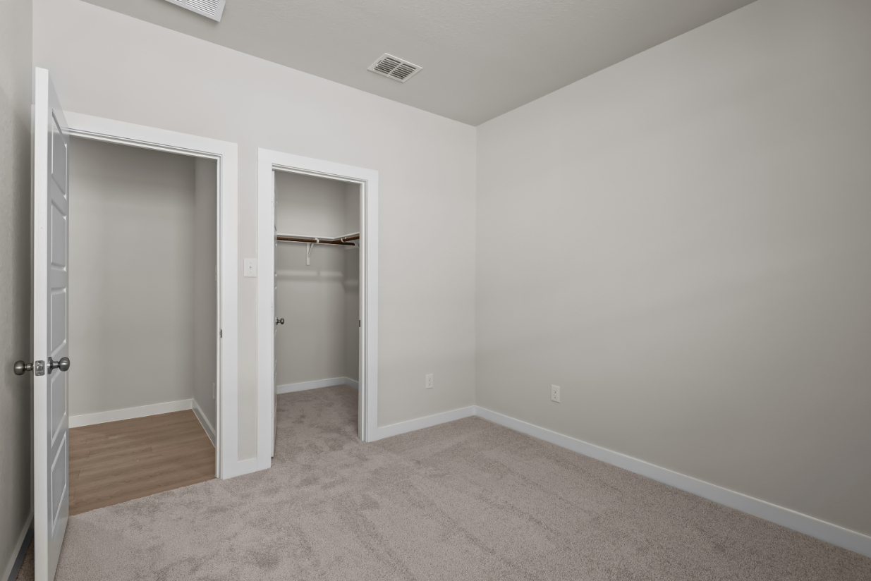 A room with a door and a shelf.