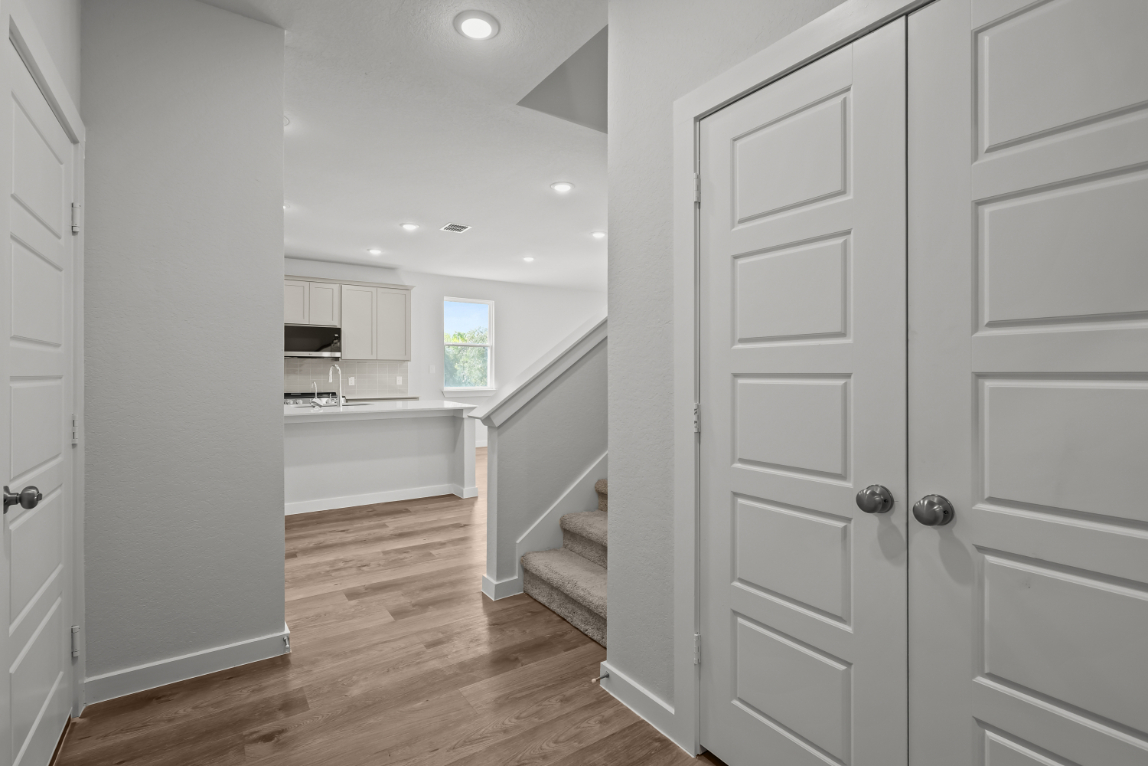 A bathroom with white cabinets.