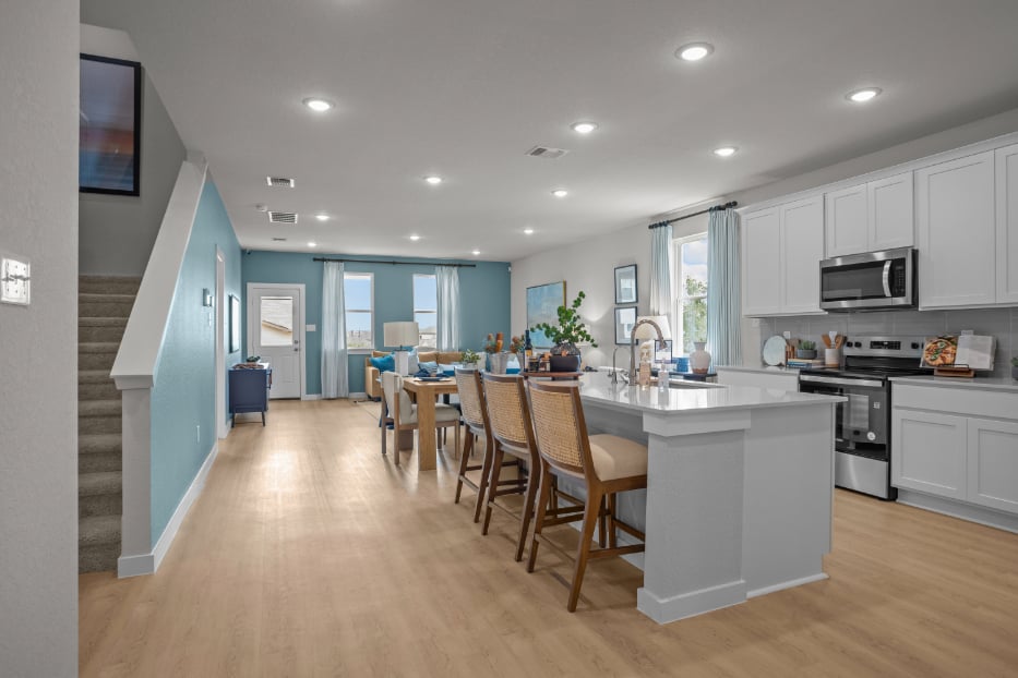 A kitchen with a wood floor.