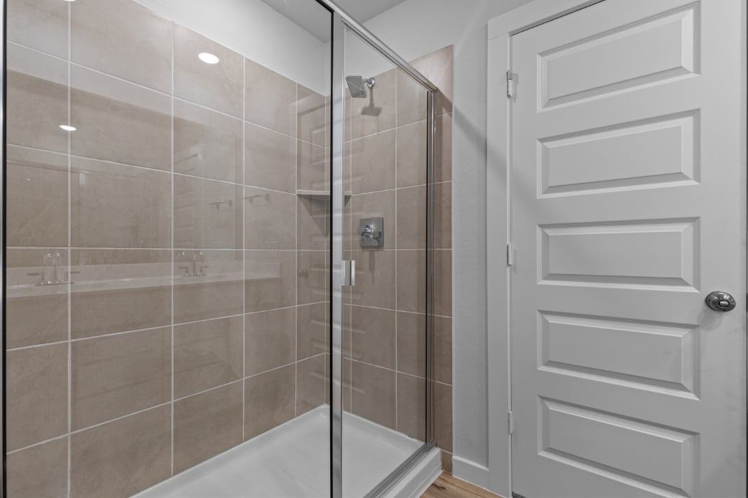 A shower with a glass door.