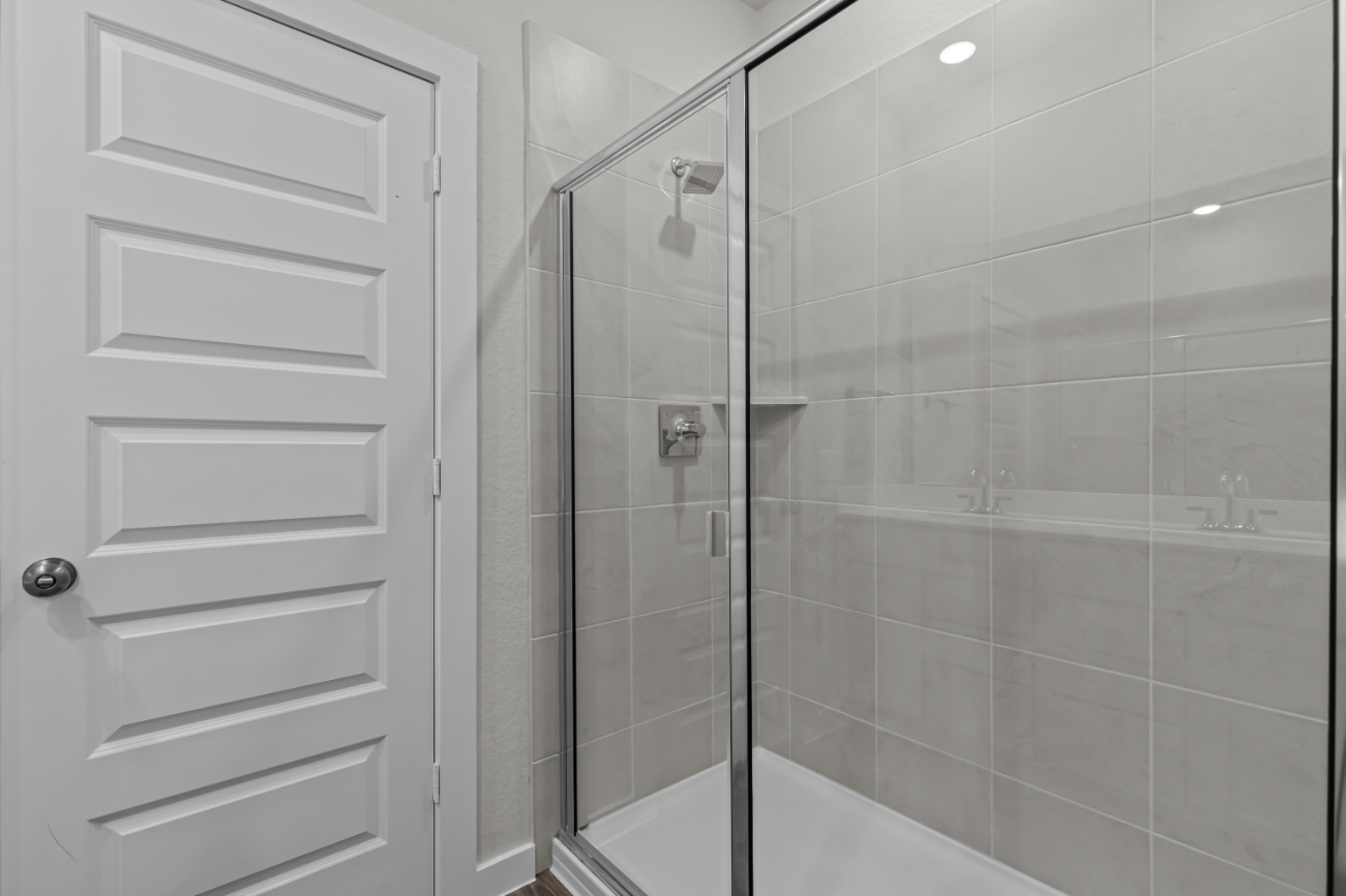 A shower with a glass door.