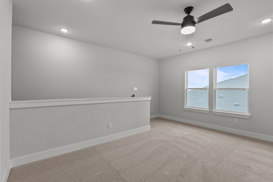 A room with a window and a fan.