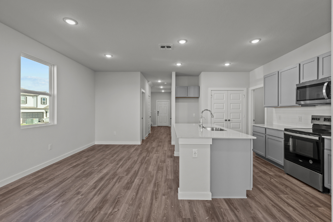 A kitchen with white cabinets.