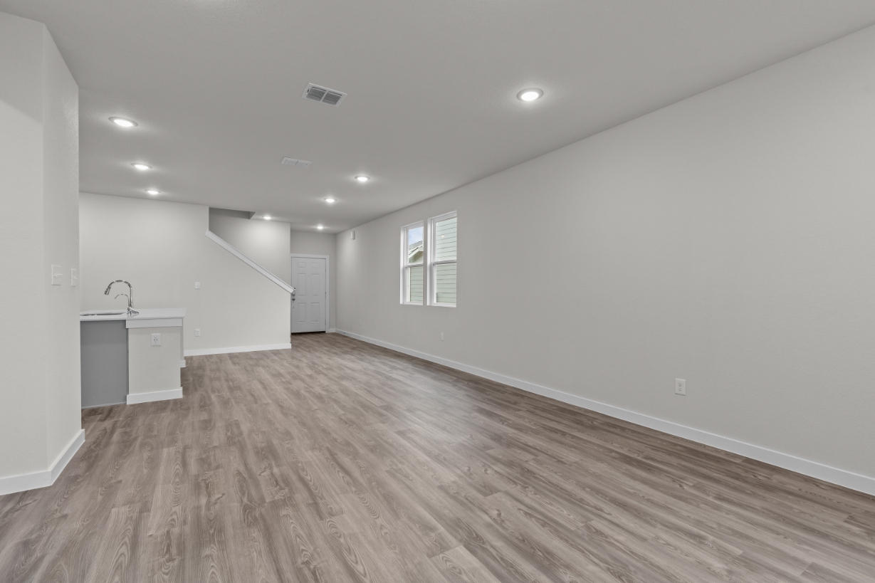 A room with a wood floor and a wood floor.