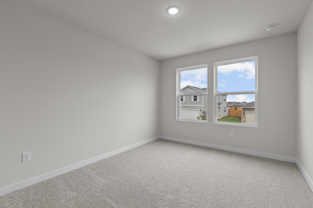 A room with a window and a carpet.