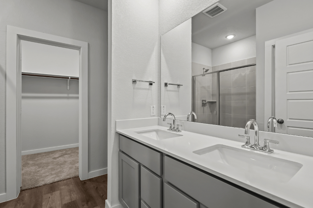 A bathroom with a large mirror.