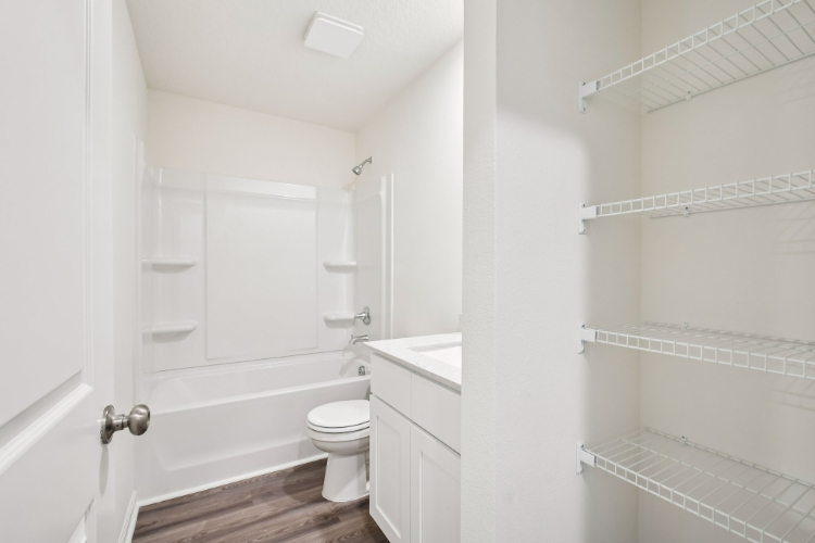 A bathroom with white walls.