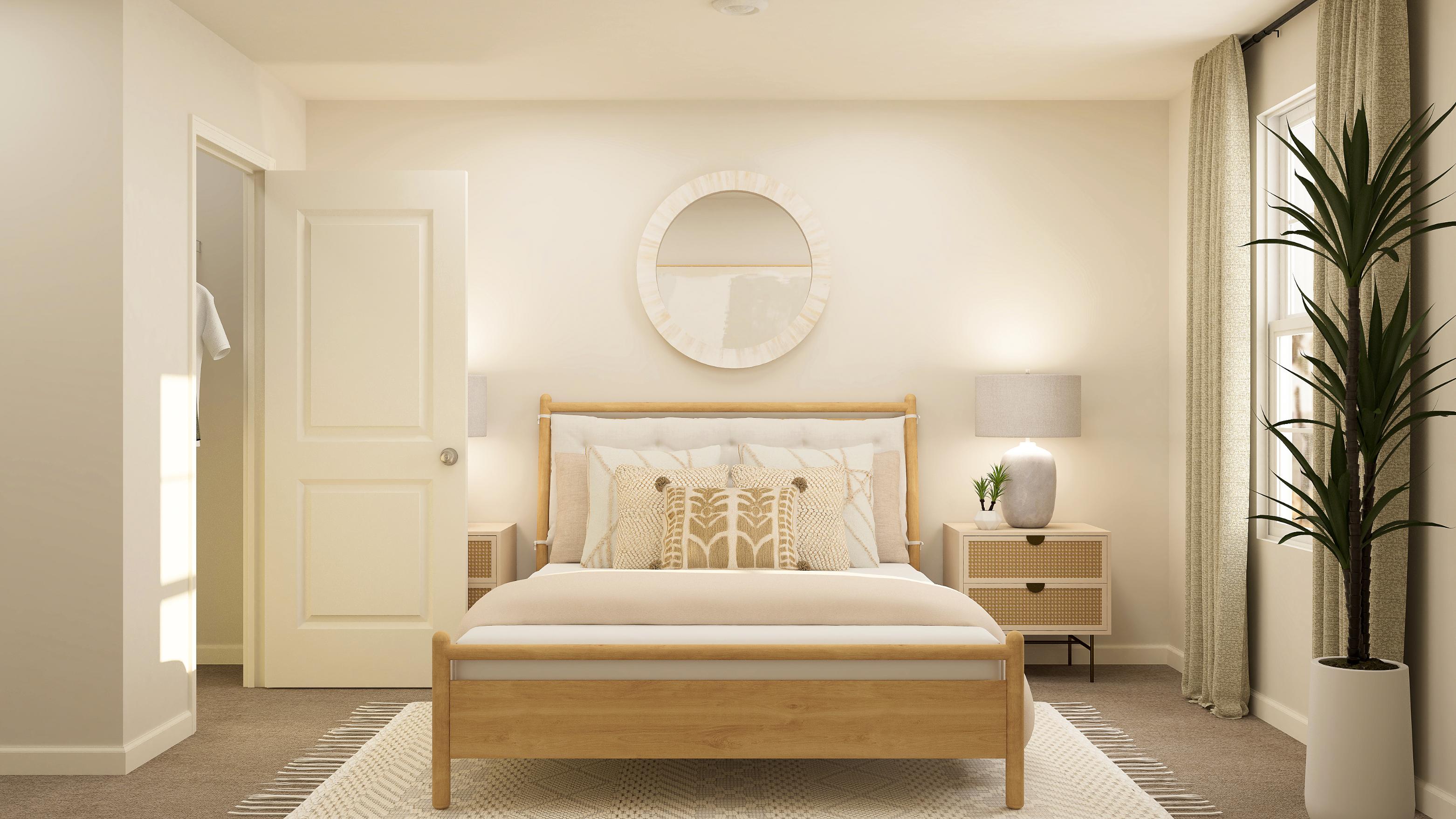 A bedroom with a bed and a mirror.