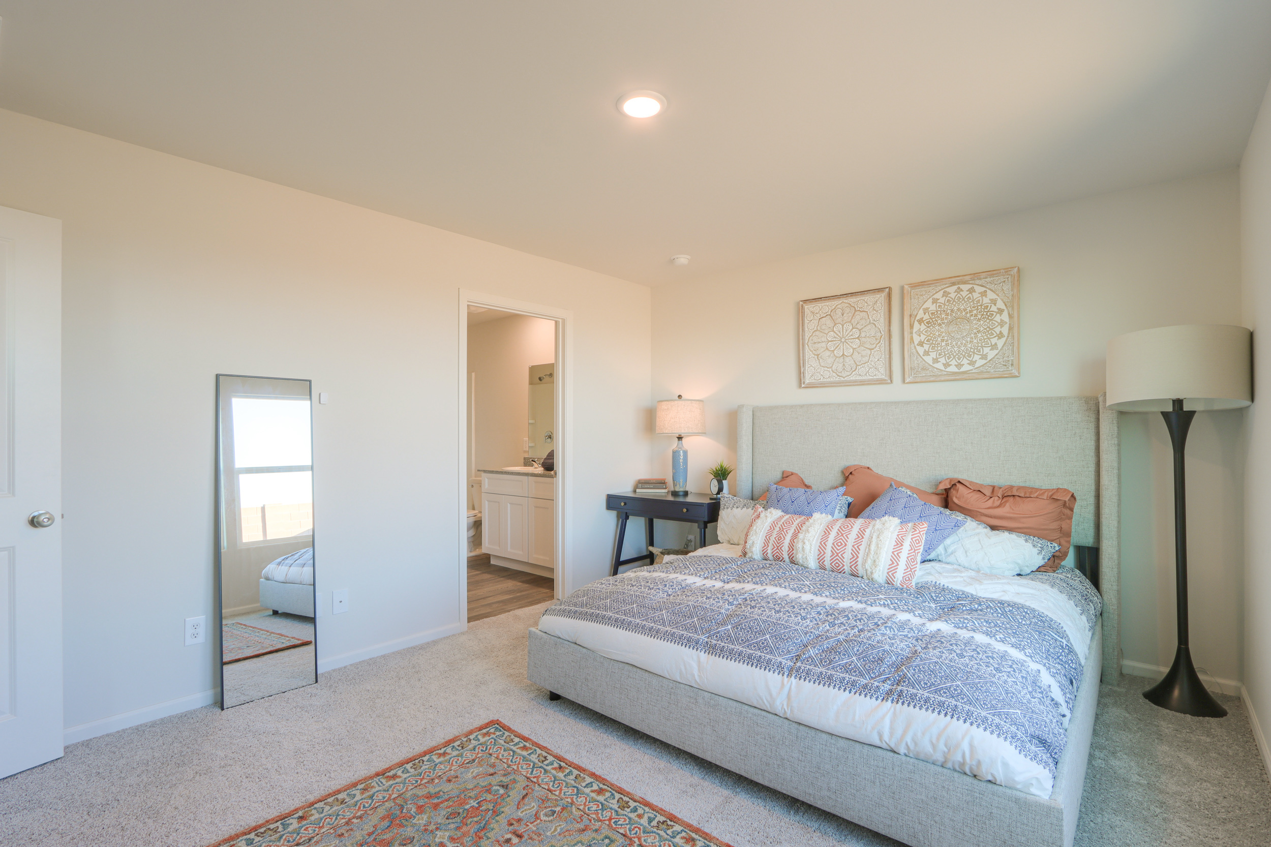 A bedroom with a bed and lamps.