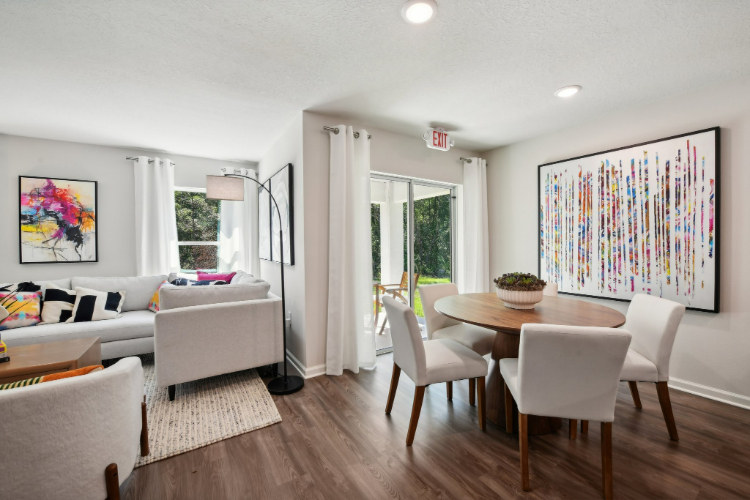 A living room with a table and chairs.