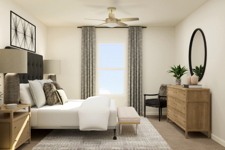 A room with a white couch and a white chair.