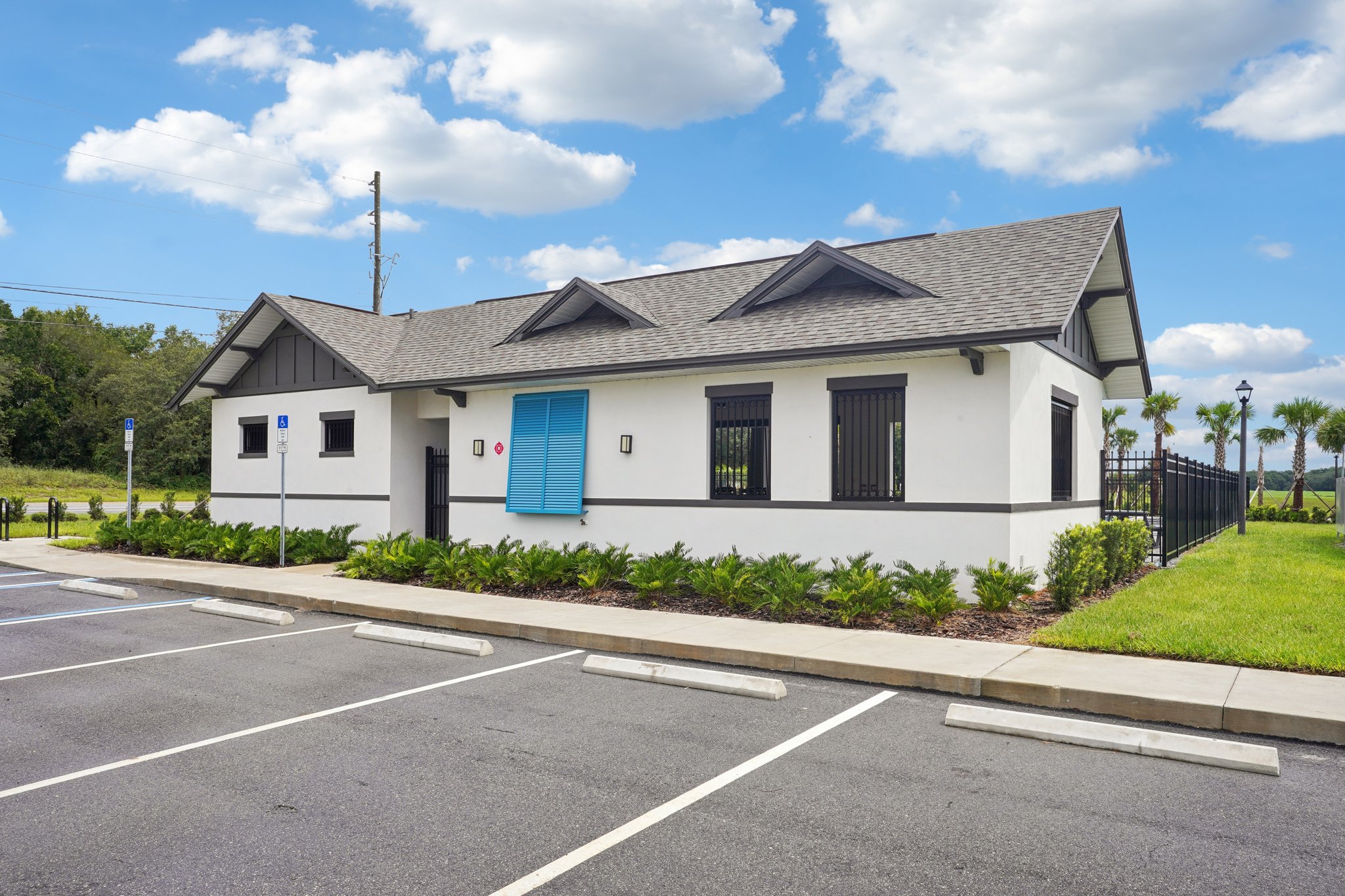 A white building with blue doors.