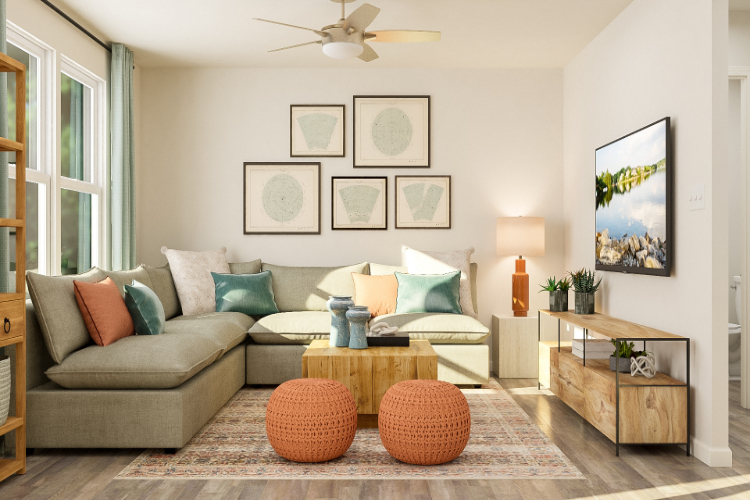 A living room with a couch and a fan.