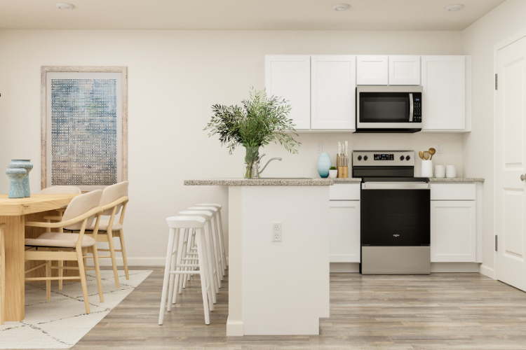 A kitchen with white cabinets.